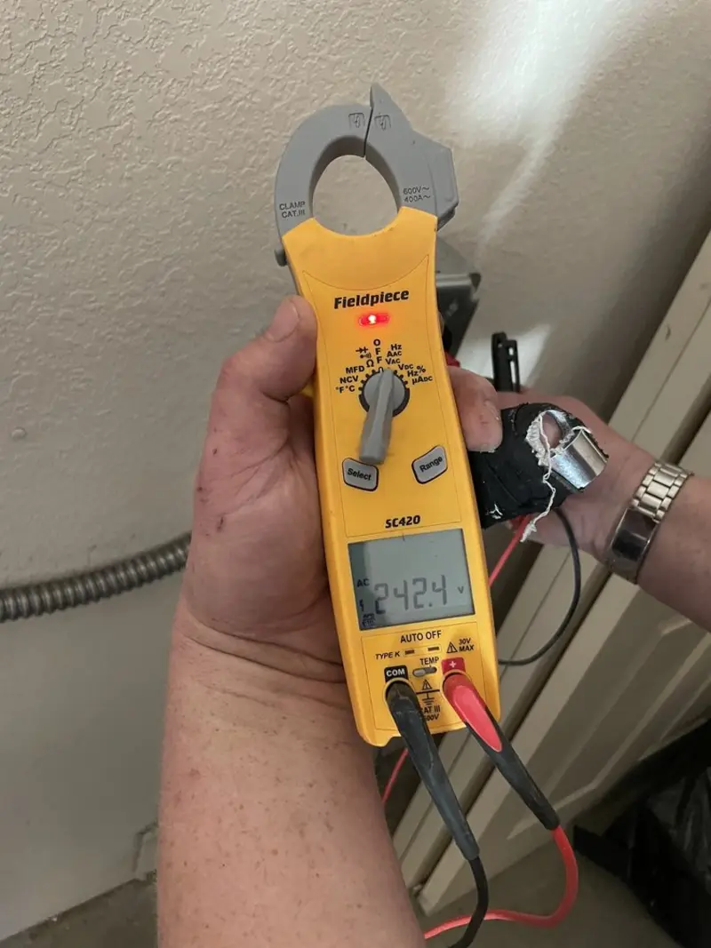 Voltage testing with clamp meter during Recessed Lighting Installation in Haddon